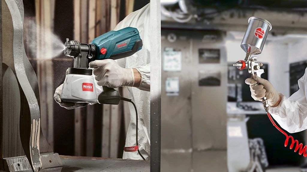 Various types of paint sprayers displayed on a workbench for comparison