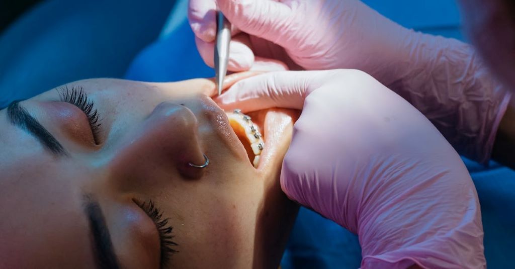 Close-up of a dentist examining a patient’s teeth, illustrating treatment options for long-term tooth pain solutions